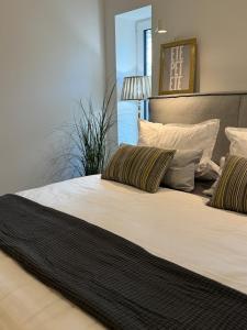 a large bed with two pillows on top of it at Sievershof Heidestrand in Wietzendorf