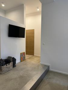 a living room with a flat screen tv on a wall at Sievershof Heidestrand in Wietzendorf