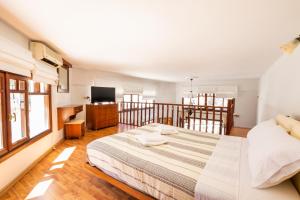 a bedroom with a large bed and a television at Melina Kyra Panagia in Kyra Panagia