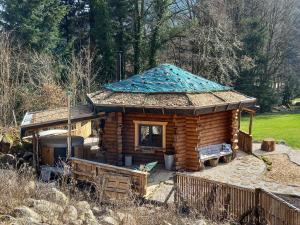 a log cabin with a blue tiled roof at LA YOURTE DU RANDONNEUR in Rimbach-près-Masevaux