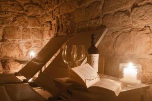 a bottle of wine and a book and a wine glass at Casa Sea La Vie in Ostuni +14 photos