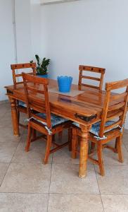 a wooden table with two chairs and a blue bowl on it at SE LO SENTI LO SAI in Triscina +19 photos