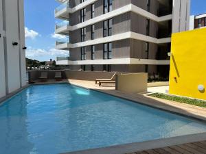 a swimming pool in front of a building at The Wharf Luxury Apartment MT 7E in Willemstad
