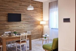 a living room with a table and a television on a wall at Plebiscito House in Castel di Sangro