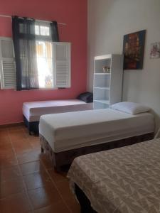 a bedroom with two beds and a window at Oxen Hostel 2024 in Recife