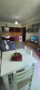 a living room with a white table with flowers on it at Perla Apartment 3 in Golem