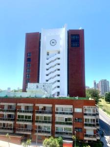 a tall building with a clock tower in front of it at Hermoso departamento frente al golf !!! in Mar del Plata