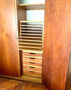 a closet with wooden shelves and a window at Hermoso departamento frente al golf !!! in Mar del Plata