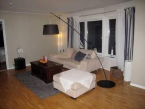 salon z kanapą i lampą w obiekcie 2 bedroom luxury apartment seafront, free pick up! w mieście Tromsø