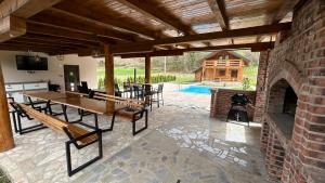 an outdoor patio with a table and a fireplace at Villa LANA Krupa na Vrbasu in Banja Luka