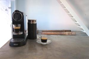 a coffee maker and a cup of coffee on a table at The Red Winehouse in Foinikiá