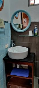 a bathroom with a sink and a mirror at Alta Vibra Appartement in Sámara