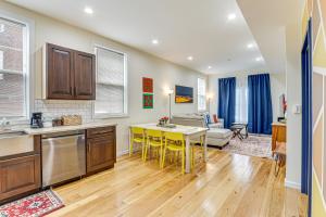 a kitchen and living room with a table and a couch at Modern New Haven Condo Less Than 1 Mi to Downtown! in New Haven