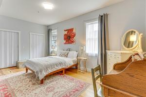 a bedroom with a bed and a dresser and a mirror at Modern New Haven Condo Less Than 1 Mi to Downtown! in New Haven
