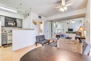 a kitchen and living room with a table and chairs at Cozy Fort Worth Condo Close to Downtown! in Fort Worth