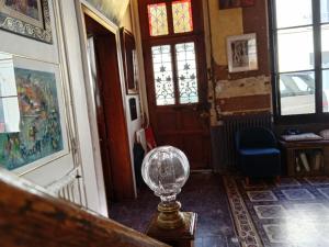 a glass ball sitting on a table in a room at Charmante et spacieuse maison de village in Courdemanche