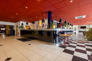 a bar in a lobby with a checkered floor at Halmstad Hotel Apartments in Halmstad