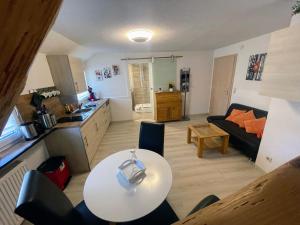 a kitchen and a living room with a table and a couch at Haus Jehle in Görwihl