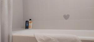 a bathroom with a bath tub with a bottle of soap at Zg City suite in Zagreb +38 photos