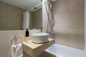 a bathroom with a white sink and a bath tub at Live Soho Boutique & Apartments Palermo Soho II in Buenos Aires