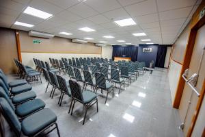 a room with rows of chairs and a podium at HOTEL GRAN PREMIUM PLAZA LTDA in Muriaé +49 photos