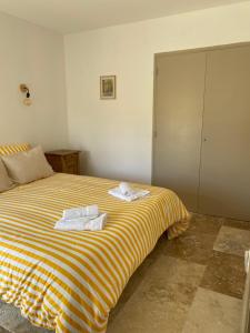 a bedroom with a bed with towels on it at Chez prune in Rasteau +37 photos