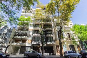 an apartment building with cars parked in front of it at Live Soho Boutique & Apartments Palermo Soho II in Buenos Aires