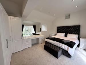 a bedroom with a bed and a desk and a window at Woodhouse Retreat in Woodhouse