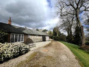 a stone house with a bench in front of it at Woodhouse Retreat in Woodhouse