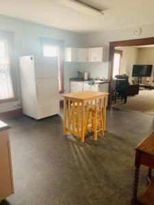 a kitchen with a table and a white refrigerator at 2BR Erie Flat Remote Work Family-Friendly in Erie