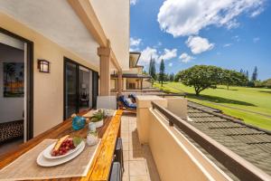 an outdoor balcony with a table with fruit on it at Kapalua Golf Villas 15T5 in Kahana
