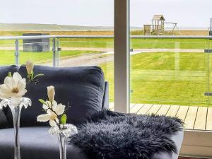 a living room with a couch and a large window at 4 person holiday home in Harbo re in Harboør