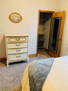 a bedroom with a dresser and a mirror on the wall at 2BR Erie Flat Near Gannon & Mercyhurst in Erie