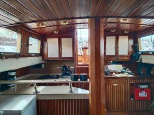 a kitchen with wooden cabinets and a sink in a train at Mondragón in Puerto de Mogán