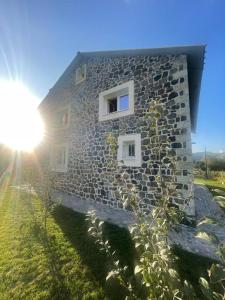 un edificio de piedra con dos ventanas laterales en 3 VELLEZERIT DOCI GUEST HOUSE, en Fushë-Lurë