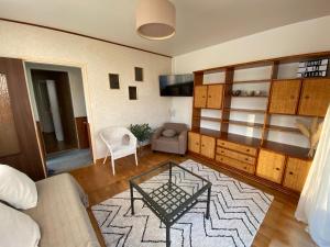 a living room with a couch and a table at Comme à la maison in La Roche-sur-Yon