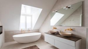 a bathroom with two sinks and a large mirror at Modern Apartment for a great stay in Helsinki