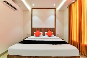 een slaapkamer met een groot bed met rode kussens bij Maurya Inn in Jodhpur