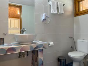 a bathroom with a sink and a toilet at Panorama Dream studios A in Vourvourou