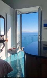 a bedroom with a view of the ocean at Casa Gargano Ravello Amalfi Coast in Amalfi