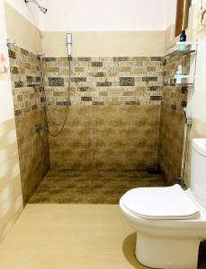 a bathroom with a shower and a toilet at Serene Stay in Kurunegala