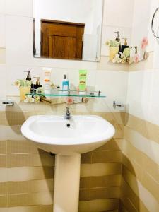 a bathroom with a sink and a mirror at Serene Stay in Kurunegala