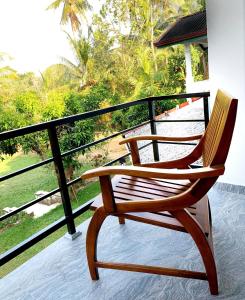 a rocking chair sitting on a balcony with a view at Serene Stay in Kurunegala