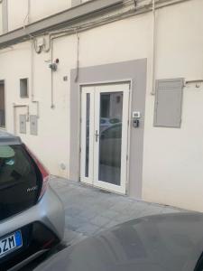 a white building with a door on the side of it at AngelHome Matera in Matera