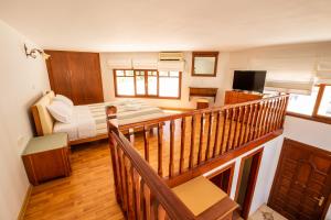 a bedroom with a bed and a balcony with a television at Melina Kyra Panagia in Kyra Panagia