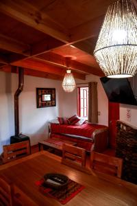 a living room with a bed and a table at Tambo Atacama Lodge in San Pedro de Atacama