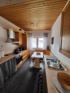 a kitchen with a sink and a table in it at Ferienwohnung Emira in Wittingen