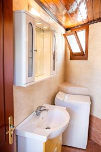 a bathroom with a sink and a toilet at Melina Kyra Panagia in Kyra Panagia +18 photos
