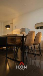 a dining room table with four chairs and a lamp at Elegant Studio in Barranco in Lima