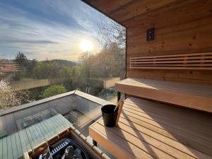 a sauna with a bench and a cup on a deck at Pettinger Stöckl in Heimschuh